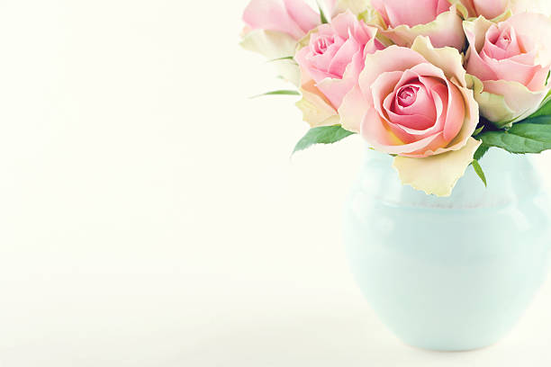 istock Pink roses in a light blue vase 186243818