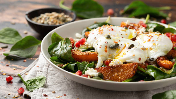 istock Roasted butternut squash salad served with poached eggs, spinach, nuts and pomegranate seeds 1862439625