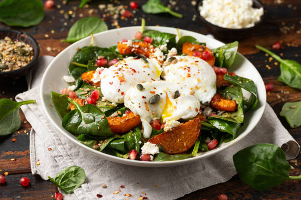 istock Roasted butternut squash salad served with poached eggs, spinach, nuts and pomegranate seeds 1862439631