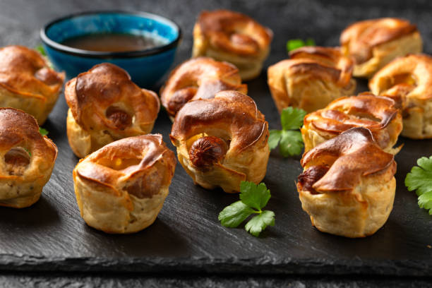 istock Mini Toad in the hole, Baked sausages in Yorkshire pudding with gravy 1862440148