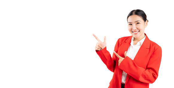 Young Asian Business woman pointing up to copy space and looking at camera with smile face and happy Pretty girl act like a satisfied product use for advertising with isolated on white background