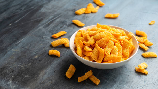 istock Crunchy Nacho cheese corn snack in white bowl 1862442225