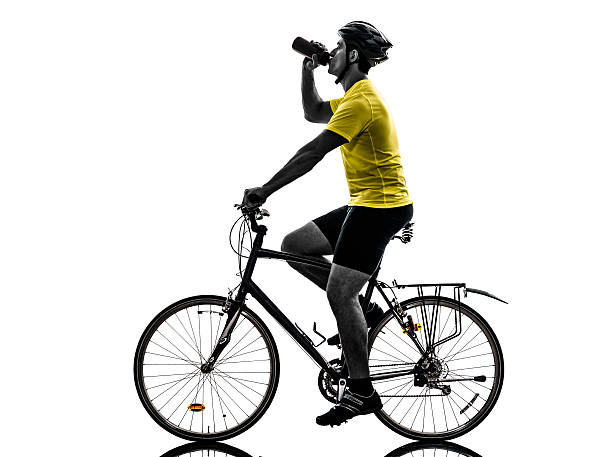 istock man bicycling mountain bike drinking silhouette 186245589