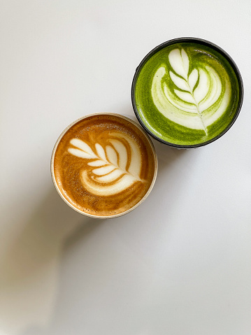 A cup of Latte  and Matcha Latte on white  table