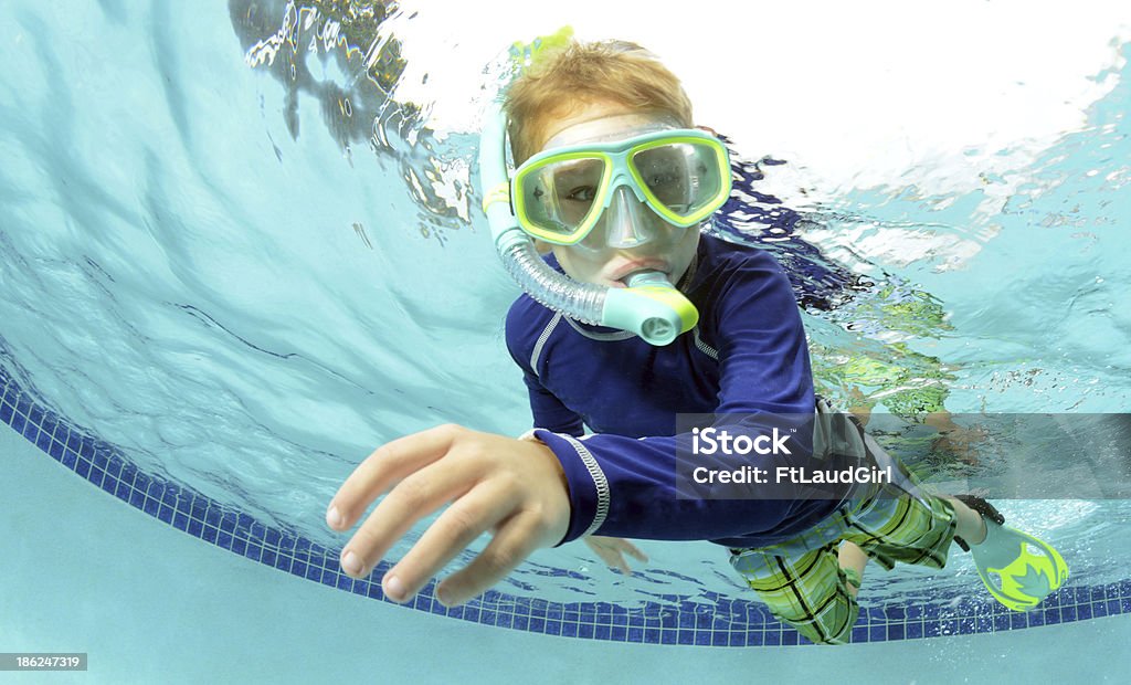 child swimming young boy swimming underwater in pool Child Stock Photo