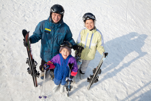 Smiling Family with Ski Gear in Ski Resort