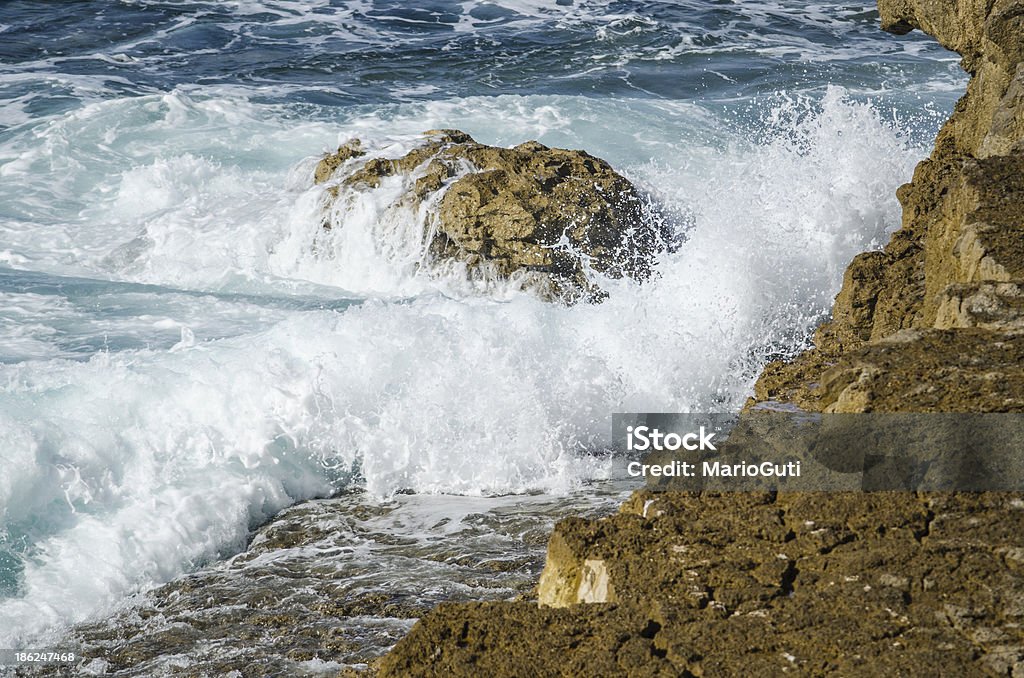 Crashing wave. A wave crashing against a cliff in northern Spain. Animal Markings Stock Photo
