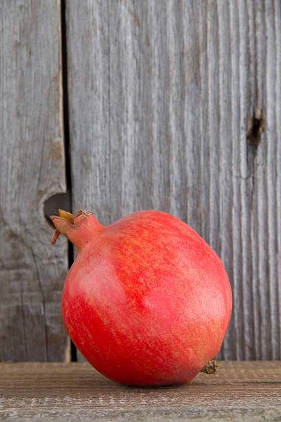 istock Juicy pomegranate and its half with leaves. 186247831