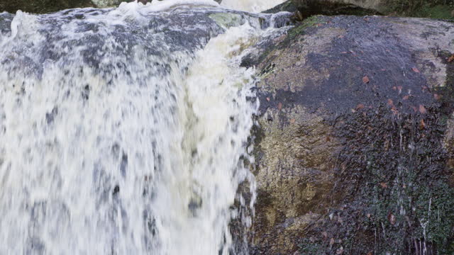 Close up of water flowing over rocks