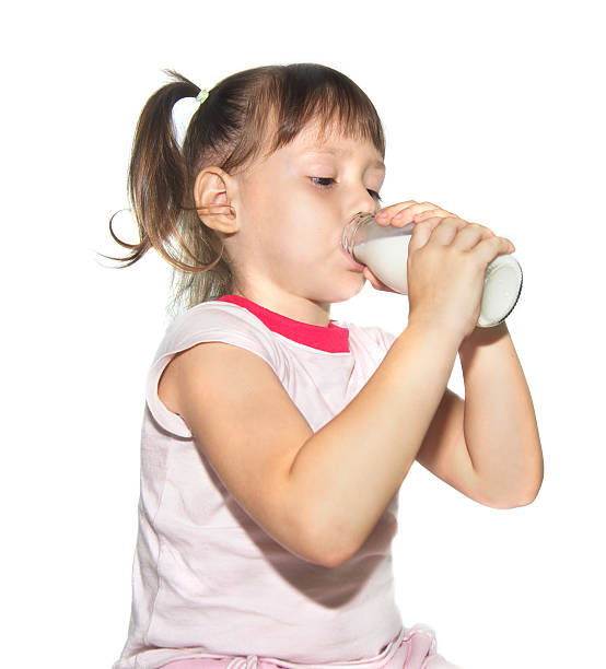 istock Cute little girl drinking milk 186250689