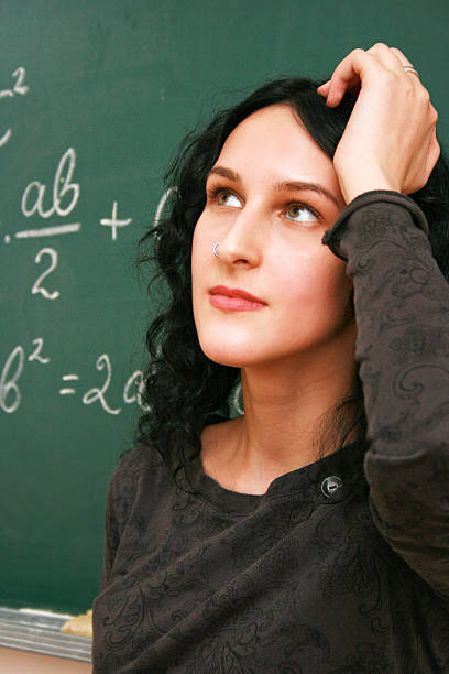 istock Young woman thinking near the blackboard 186250965