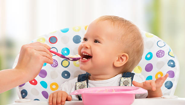 istock Baby is happy being fed by mother 186251243