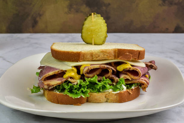 pastrami sandwich top with cheese  and mustard