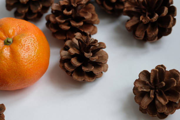 istock tangerine and fir cones on the table 1862540639