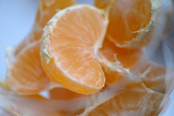 istock peeled tangerine slices in a glass 1862541173