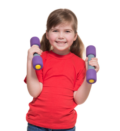 Little girl holding small barbell for fitness on white background