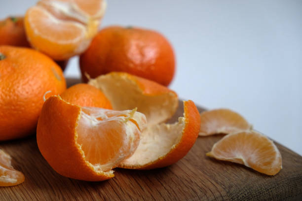 istock tangerines on a wooden cutting board 1862542208