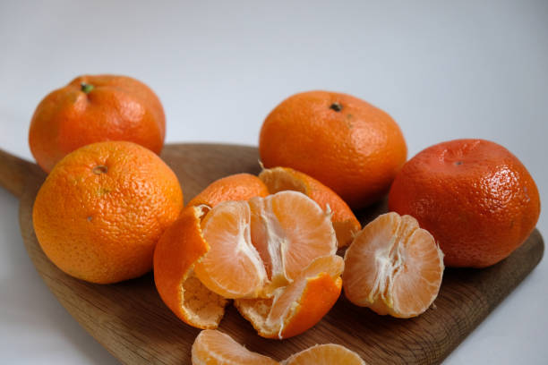 istock tangerines on a wooden cutting board 1862542214