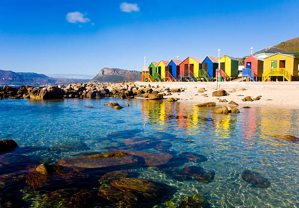 St James Beach, Cape Town Crystal clear water of St James Beach and tidal pool with its colourful huts, Cape Town, South Africa tidal pool stock pictures, royalty-free photos & images