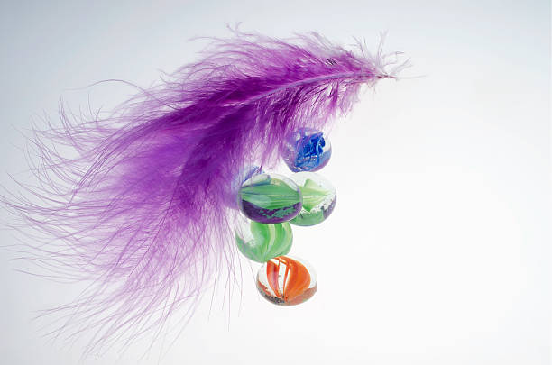 Purple feather and decorative stones. stock photo