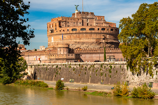 Rome, Italy: December 01, 2019 : The view of the Castel Sant'Angelo (now a national museum) and statues of angel figure on the Sant'Angelo bridge.
