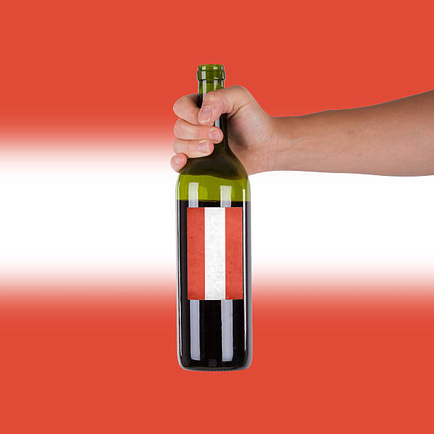 istock Hand holding a bottle of red wine 186258506
