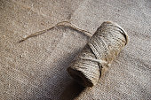 Skeins of thread on burlap. Yellow threads on coarse cloth.