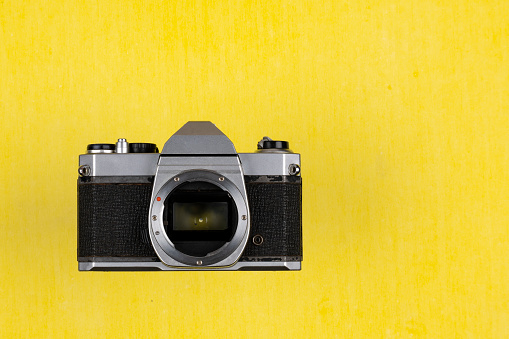 Vintage Film Camera isolated on yellow background