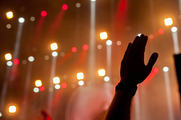 istock cheering crowd in front of bright stage lights 186261054