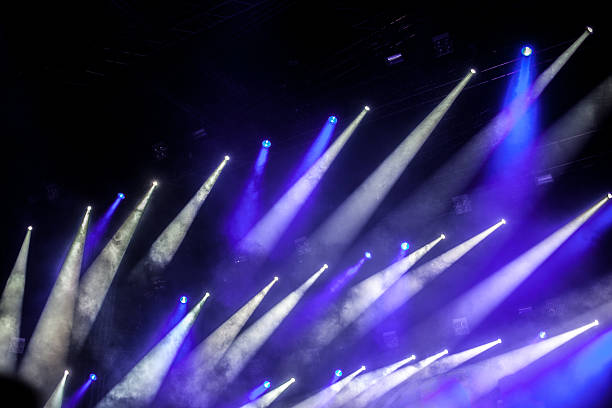 istock cheering crowd in front of bright stage lights 186261736