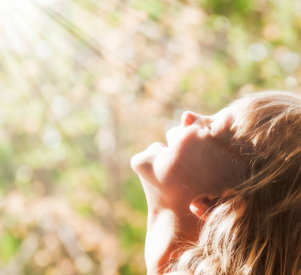 Child and the Sun A young child smiling rays of the sun religion sunbeam one person children only stock pictures, royalty-free photos & images