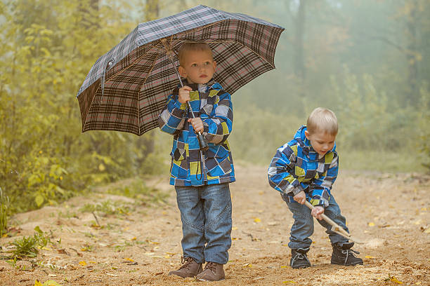 istock Two young brothers playing in autumn park 186264280