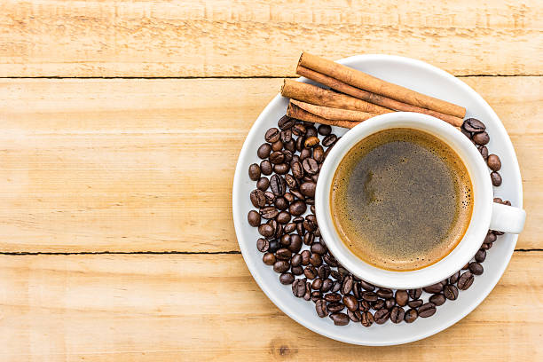 istock coffee in white cup and cinnamon on wood background 186264489