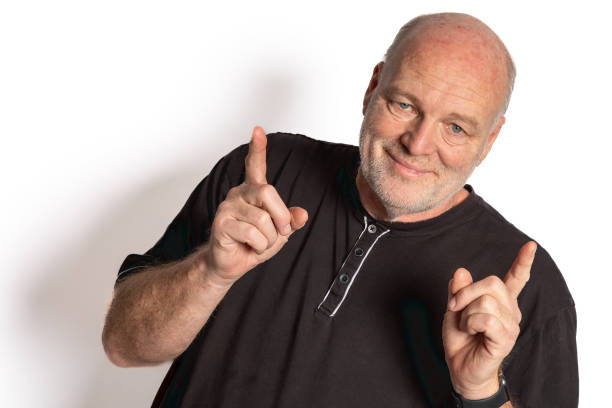 istock Confident 58-Year-Old White Male Pointing Up, Portrait on White Background 1862645983