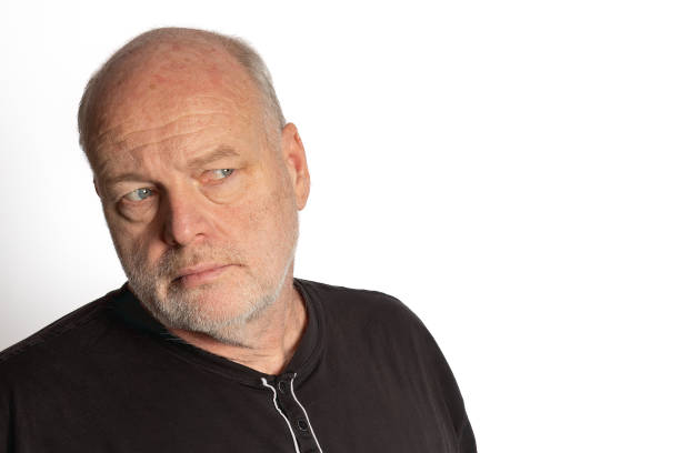 Middle-aged White Man in Black Shirt Looking Suspiciously Right on White Background
