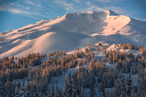 First light graces the slopes of Mount Bachelor in Oregon, seen from the Cascade Lakes Highway