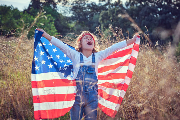 istock Excited child with USA flag in nature 1862665892