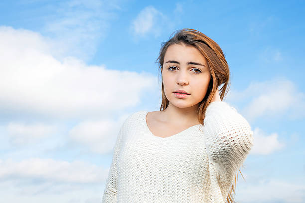 Beautiful woman with a sky with clouds background