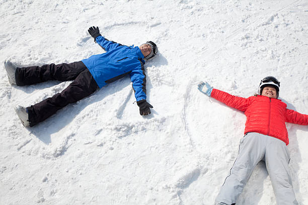 istock Couple Lying Making Snow Angel 186268316