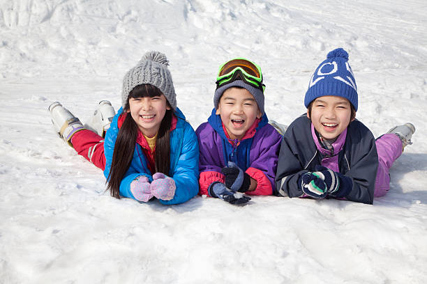 istock Children Lying on the Snow 186268319