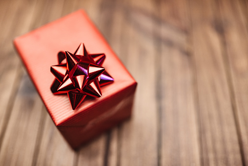 close-up of red giftbox with green ribbon and bow