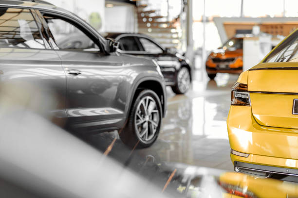 Car Dealership Office Car parked in luxury showroom. Car dealership office. New car parked in modern showroom. Car for sale and rent business concept. Automobile leasing and insurance concept. empty dealership interior stock pictures, royalty-free photos & images