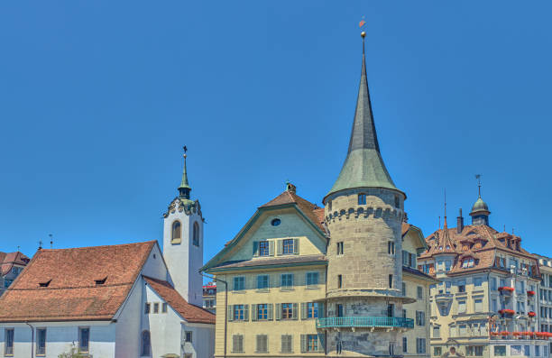 Lucerne, Switzerland, view of the Corner tower (also known as Greider tower) and the St. Peter bell tower  on the Reuss River Banks