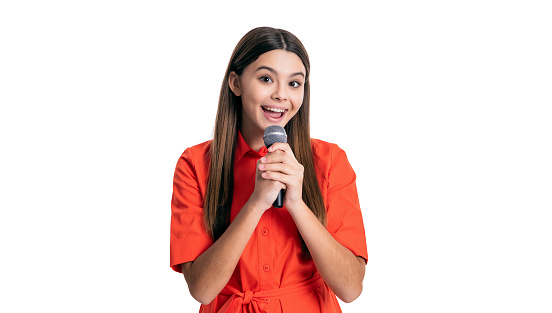 amazed teen girl singer singing with microphone isolated on white. teen girl singer holding microphone in studio. teen girl singer with singing microphone. photo of singer teen girl hold microphone.