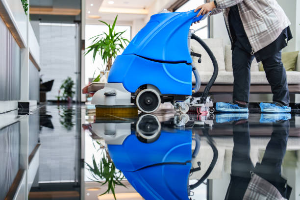 Female worker cleaning office lobby floor with machine stock photo