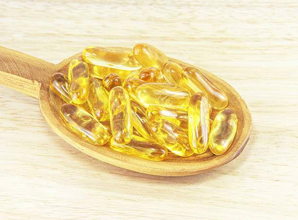 istock Fish oil capsules on wooden spoon 186278862