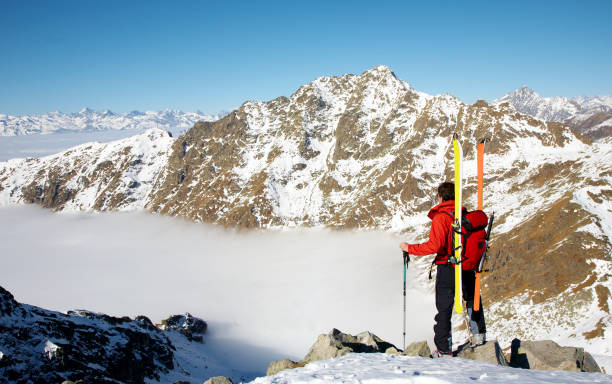 A captivating image of an adventurer during a ski expedition on a breathtakingly beautiful mountain. stock photo