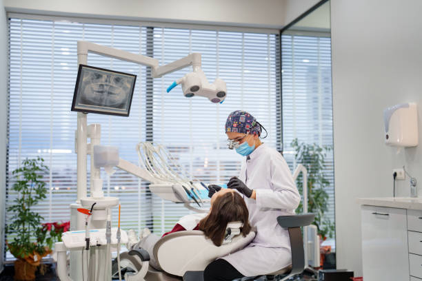 치과 의사가 진료실의 의자에서 환자의 치아를 검사하고 있습니다. - dentist office dentists chair dental equipment medical equipment 뉴스 사진 이미지