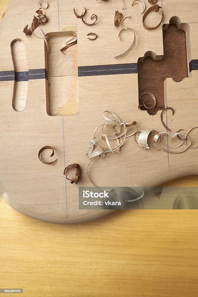 Bass guitar under construction Bass guitar under construction, with tools and accessories. Acoustic Guitar Stock Photo