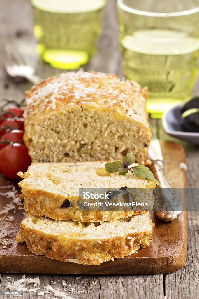 Savoury loaf cake with tomatoes, cheese and olives Appetizer Stock Photo